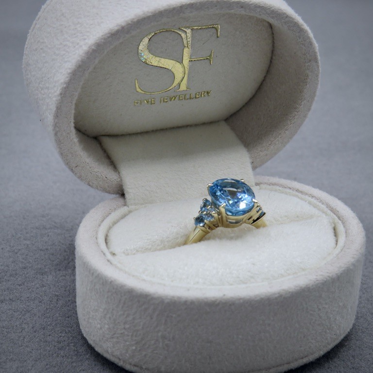 Blue stone and yellow gold ring in a box