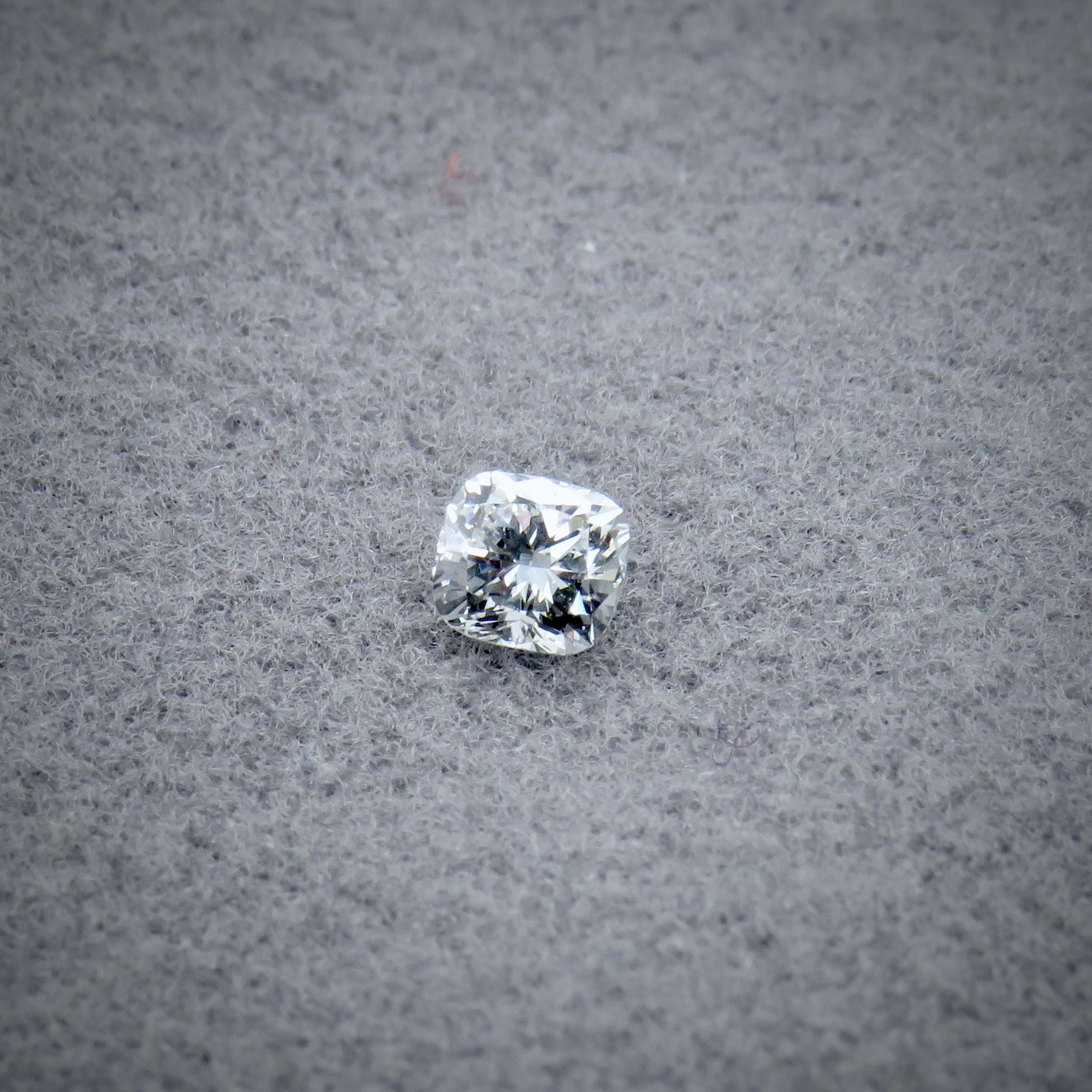 Cushion cut diamond on grey background