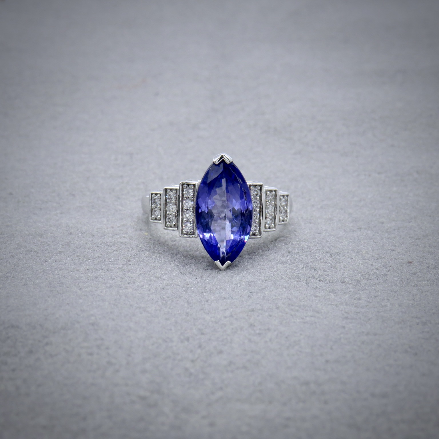 Purple Marquise shape stone with white diamonds on the side