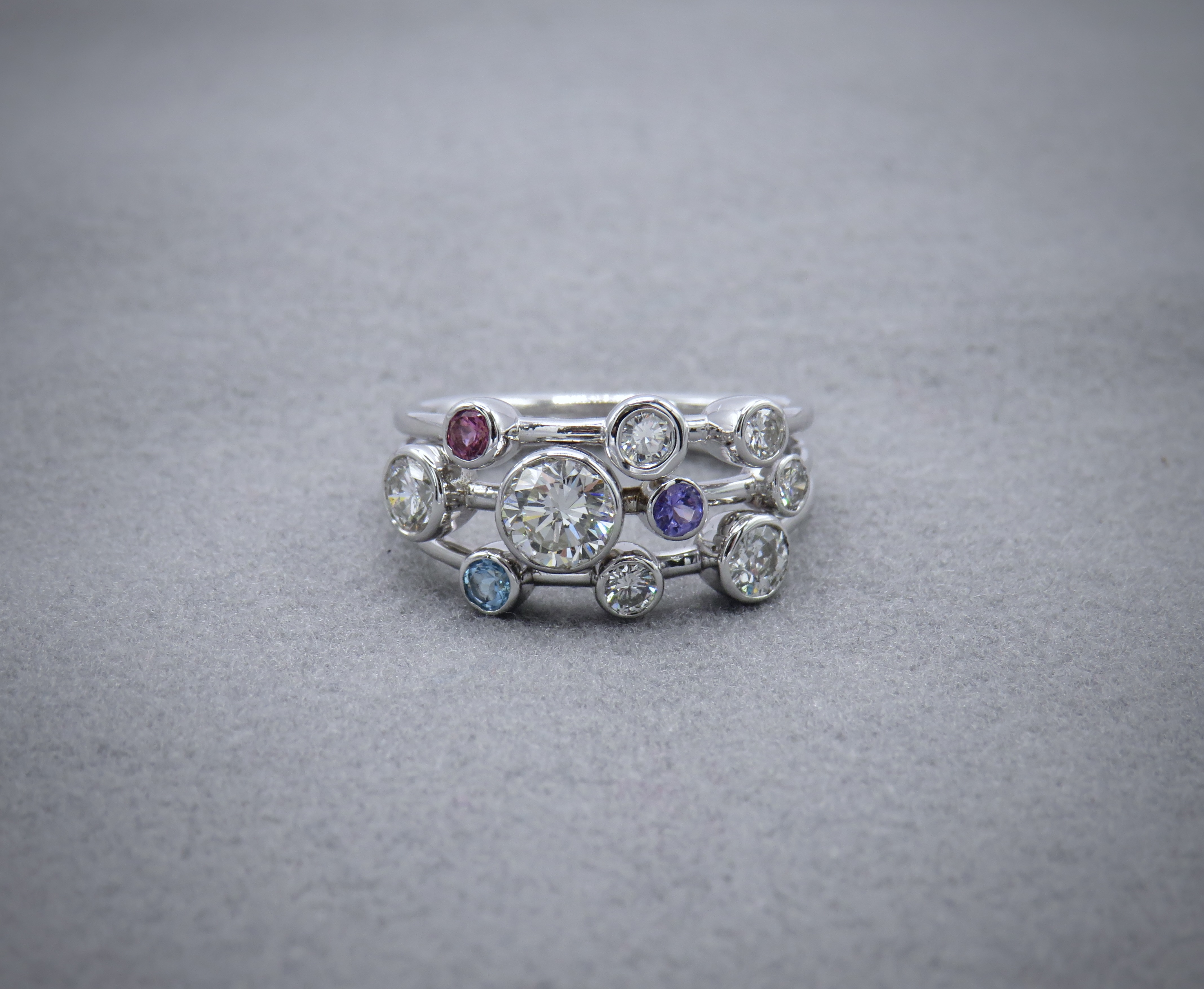 Diamond, topaz, tanzanite, tourmaline scatter ring in white gold