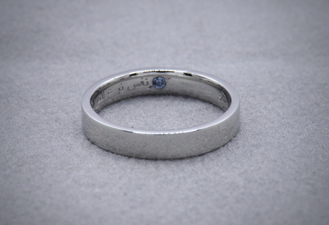 Platinum wedding band with inlaid sapphire