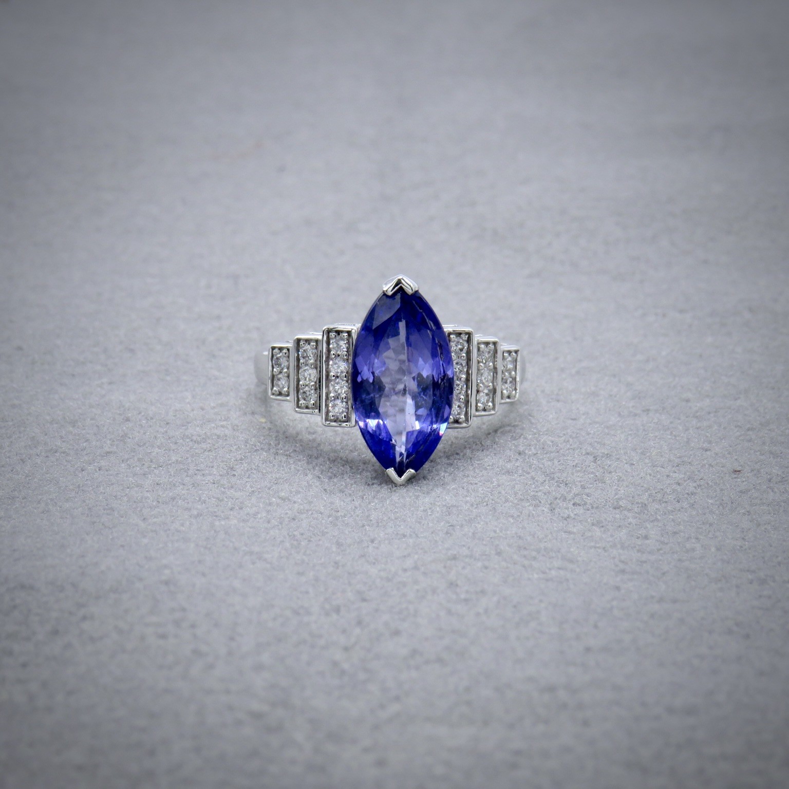 marquise tanzanite ring with step diamond shoulders