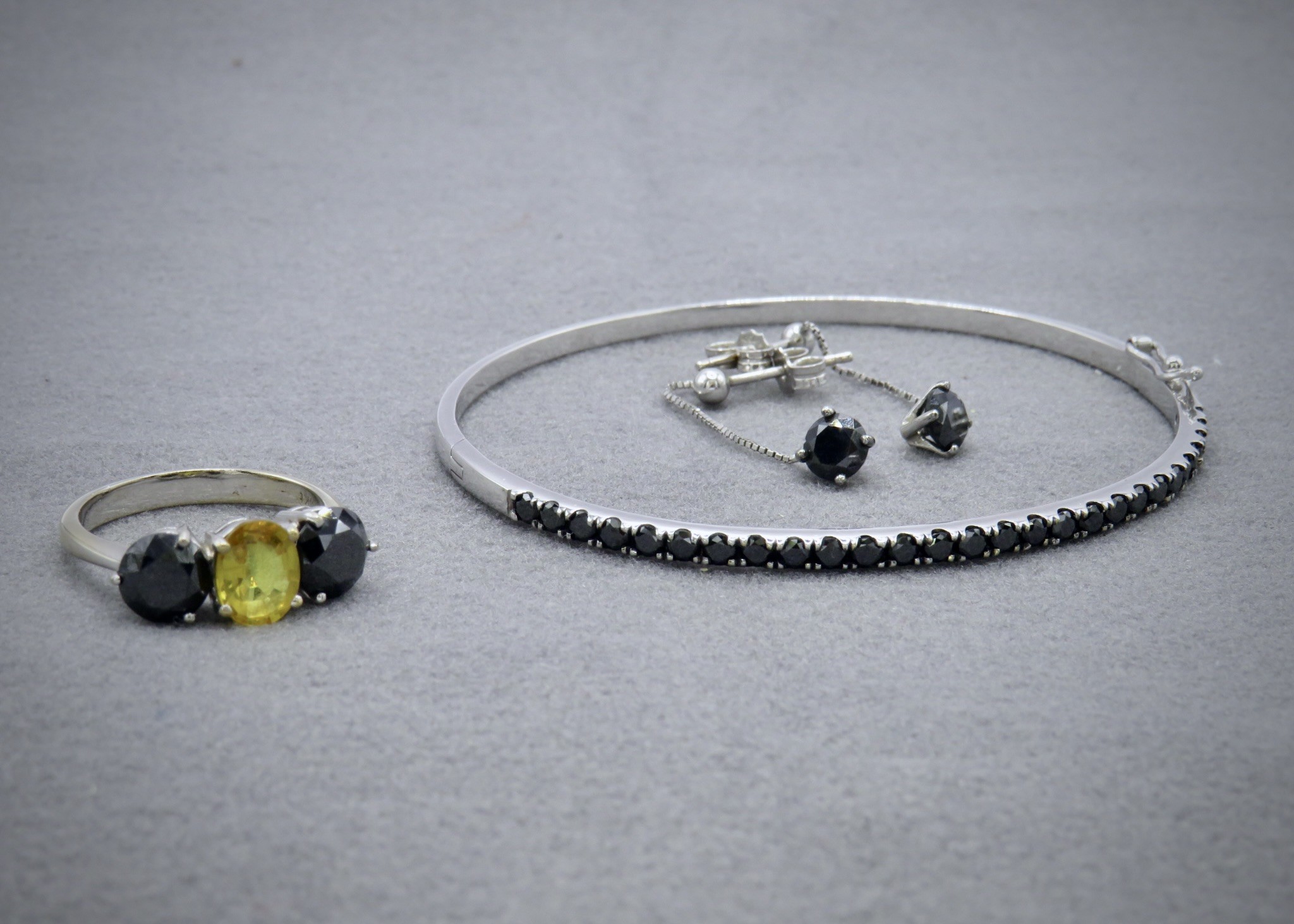 black diamond earrings, bracelet and trilogy black diamond and yellow sapphire ring