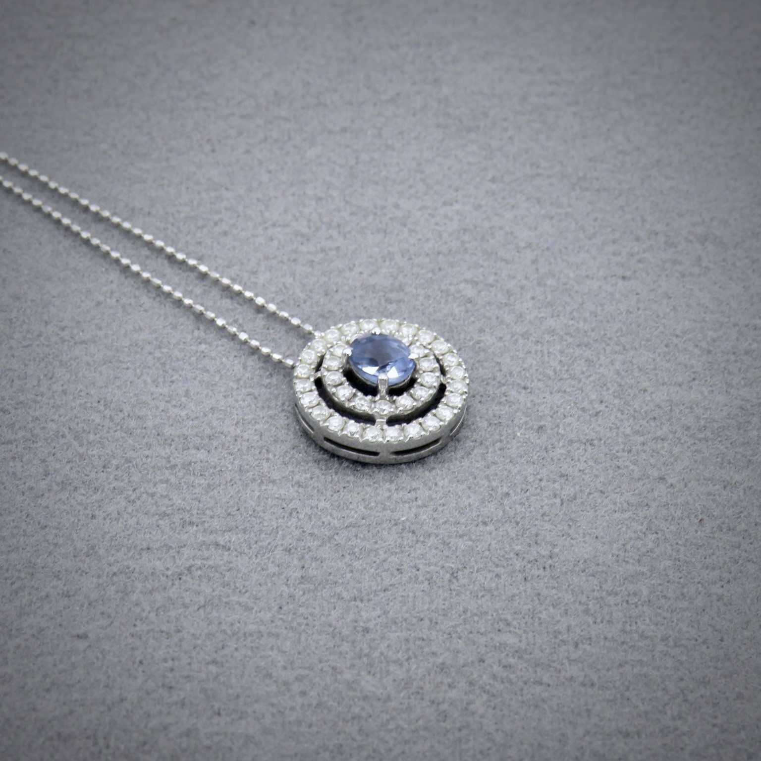 blue sapphire pendant with double halo of diamonds