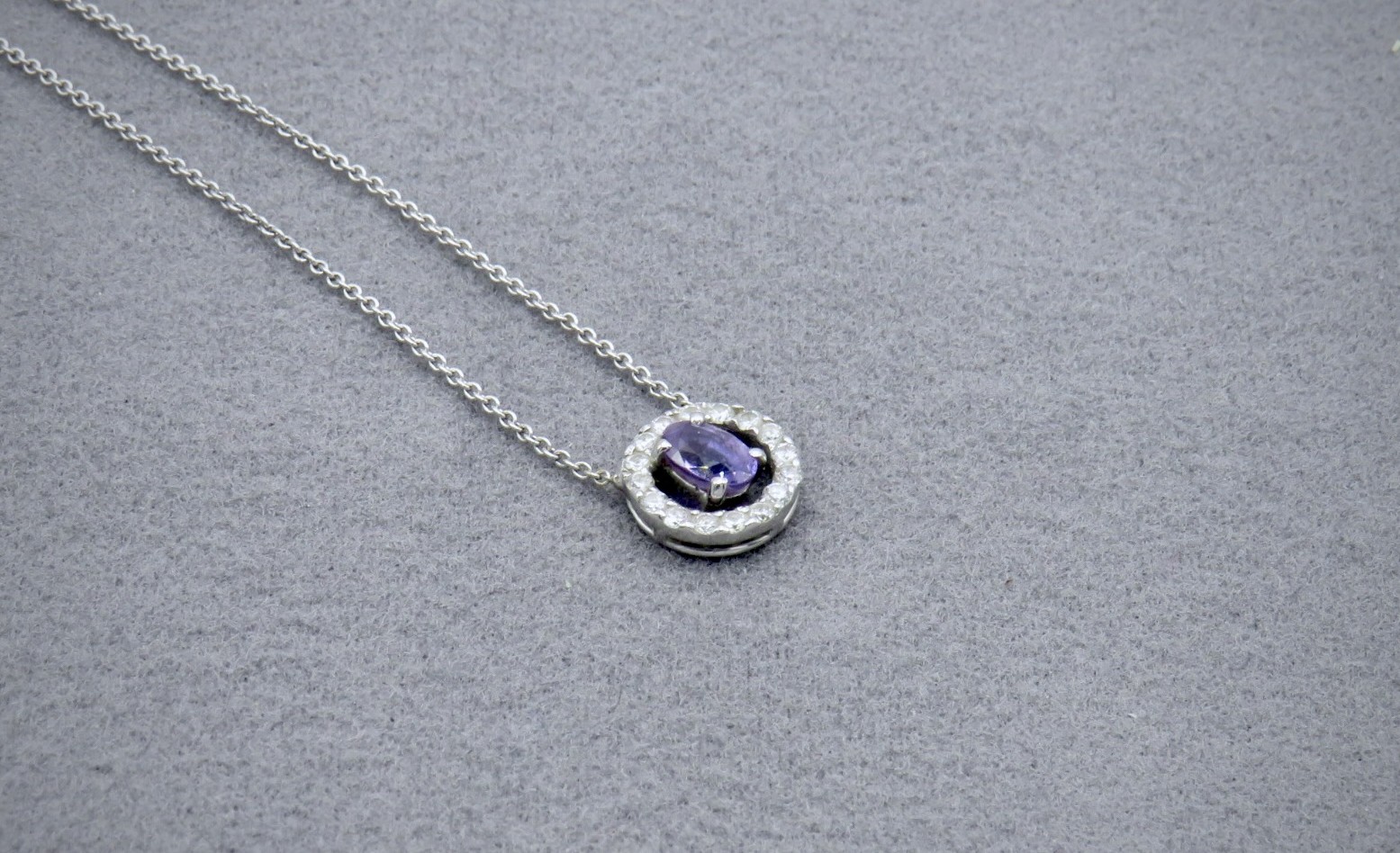 purple sapphire pendant surrounded by diamonds