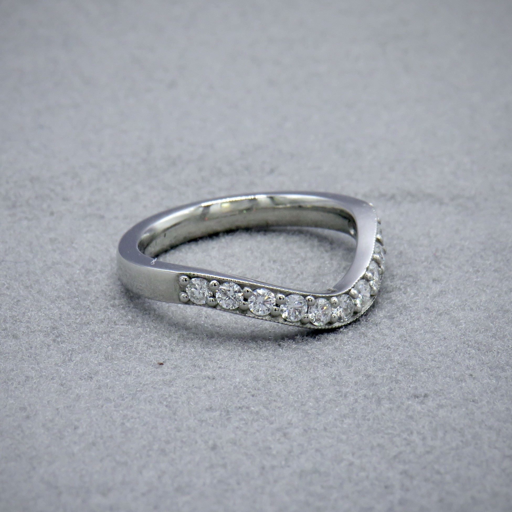 Curved wedding ring with diamonds